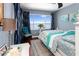 Bright bedroom featuring beach decor, wood floors, and a large window with water view at 2111 Alexis Ct, Tarpon Springs, FL 34689