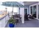 Outdoor deck with patio seating, an umbrella, and a beautiful view of neighborhood at 2111 Alexis Ct, Tarpon Springs, FL 34689