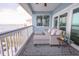 Outdoor seating area on a balcony with views of the bay and blue skies at 2111 Alexis Ct, Tarpon Springs, FL 34689