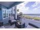 Outdoor seating area on a large covered deck with beautiful views of the water at 2111 Alexis Ct, Tarpon Springs, FL 34689