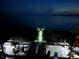 Night view of illuminated private dock extending into calm waters for peaceful evenings at 2111 Alexis Ct, Tarpon Springs, FL 34689
