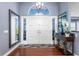 Elegant foyer with double doors, hardwood floors, and an arched window above the entrance at 2111 Alexis Ct, Tarpon Springs, FL 34689