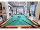 Large game room featuring a pool table and an outdoor patio area at 2111 Alexis Ct, Tarpon Springs, FL 34689