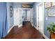 Spacious hallway with hardwood floors and elegant french doors leading into other rooms at 2111 Alexis Ct, Tarpon Springs, FL 34689