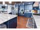 Modern kitchen with blue cabinets, stainless steel appliances, and granite countertops, perfect for cooking at 2111 Alexis Ct, Tarpon Springs, FL 34689