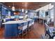 Spacious kitchen with island, marble countertops, custom blue cabinetry, and open layout, excellent for gatherings at 2111 Alexis Ct, Tarpon Springs, FL 34689