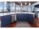 Kitchen island featuring granite countertop, custom blue cabinetry, and stainless steel appliances with water views at 2111 Alexis Ct, Tarpon Springs, FL 34689