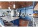 Bright kitchen featuring blue cabinets, stainless appliances, wood ceiling and hardwood floors at 2111 Alexis Ct, Tarpon Springs, FL 34689