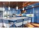 Bright kitchen showcasing blue cabinets, wooden ceiling, island and stainless appliances at 2111 Alexis Ct, Tarpon Springs, FL 34689