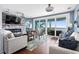 Comfortable living room with fireplace, sliding glass doors to the patio, and stylish furnishings at 2111 Alexis Ct, Tarpon Springs, FL 34689