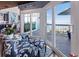 Sitting room with beautiful lake view, seating, and access to the outdoor deck through sliding glass doors at 2111 Alexis Ct, Tarpon Springs, FL 34689