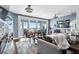 Bright living room with access to the balcony, cozy seating, and stylish decor at 2111 Alexis Ct, Tarpon Springs, FL 34689