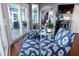 Cozy sitting area with patterned blue chairs, hardwood floors, and sliding doors to an outdoor deck at 2111 Alexis Ct, Tarpon Springs, FL 34689