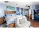 Spacious bedroom with hardwood floors, king bed, sitting area, and accent lighting at 2111 Alexis Ct, Tarpon Springs, FL 34689