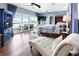 Bedroom with chaise lounge seating and water views from sliding glass doors leading to private deck at 2111 Alexis Ct, Tarpon Springs, FL 34689