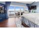 Bedroom with water views from sliding glass doors leading to a private balcony at 2111 Alexis Ct, Tarpon Springs, FL 34689