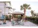 This outdoor kitchen and seating area includes a fire pit and outdoor grill at 2111 Alexis Ct, Tarpon Springs, FL 34689
