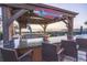 Outdoor kitchen and bar, complete with MargaritaVille sign, parrot statue and view of the Gulf at 2111 Alexis Ct, Tarpon Springs, FL 34689