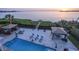 Beautiful backyard with pool, beach access, covered seating, and plenty of room to enjoy the ocean view at 2111 Alexis Ct, Tarpon Springs, FL 34689