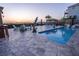 The backyard offers a patio, pool, outdoor seating, dolphin statue and sunset ocean views at 2111 Alexis Ct, Tarpon Springs, FL 34689