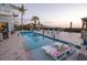 Backyard pool with lounge chairs, palm trees, gazebo, and view of the water at 2111 Alexis Ct, Tarpon Springs, FL 34689