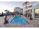 Backyard includes a pool, outdoor kitchen, multiple seating areas, palm trees and manicured hedges at 2111 Alexis Ct, Tarpon Springs, FL 34689