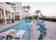 Backyard pool surrounded by patio, lounge chairs, and view of the home at 2111 Alexis Ct, Tarpon Springs, FL 34689