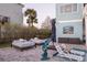 Poolside view with lounge chairs, dolphin statue, and outdoor umbrella at 2111 Alexis Ct, Tarpon Springs, FL 34689