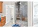 Modern shower with rainfall showerhead, bench seating, and stylish tiling at 2111 Alexis Ct, Tarpon Springs, FL 34689