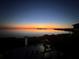 Expansive sunset view over tranquil water with private dock access from the backyard at 2111 Alexis Ct, Tarpon Springs, FL 34689
