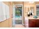 Light bathroom with a vanity that opens to the pool area at 2671 Lakebreeze S Ln, Clearwater, FL 33759