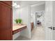 Well-lit bathroom vanity with wooden cabinets and light countertops at 2671 Lakebreeze S Ln, Clearwater, FL 33759