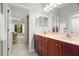 Bright bathroom featuring a double vanity, neutral countertops and tile flooring at 2671 Lakebreeze S Ln, Clearwater, FL 33759
