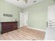 This bedroom features wood floors, a dresser, and a ceiling fan at 2671 Lakebreeze S Ln, Clearwater, FL 33759