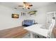 A flexible bonus room with surfboard decor, a ceiling fan, and hardwood floors, with surfboards for an easy conversion at 2671 Lakebreeze S Ln, Clearwater, FL 33759