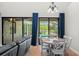 Bright dining area with table for six and view of pool and screened lanai at 2671 Lakebreeze S Ln, Clearwater, FL 33759
