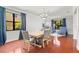 Elegant dining area with hardwood floors, stylish lighting, and ample seating for entertaining at 2671 Lakebreeze S Ln, Clearwater, FL 33759
