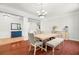 Elegant dining area with hardwood floors, stylish lighting, and ample seating for entertaining at 2671 Lakebreeze S Ln, Clearwater, FL 33759