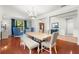 Elegant dining area with hardwood floors, stylish lighting, and ample seating for entertaining at 2671 Lakebreeze S Ln, Clearwater, FL 33759