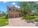 Charming two-story home with a well-maintained lawn, double garage, and a beautiful terracotta tile roof at 2671 Lakebreeze S Ln, Clearwater, FL 33759