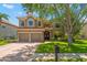 Charming two-story home with a well-maintained lawn, double garage, and a beautiful terracotta tile roof at 2671 Lakebreeze S Ln, Clearwater, FL 33759