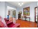 Open flex space with wood floors and an adjacent bedroom, office area, and pool access at 2671 Lakebreeze S Ln, Clearwater, FL 33759