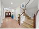 Inviting foyer area featuring a staircase and beautiful entryway with double front doors at 2671 Lakebreeze S Ln, Clearwater, FL 33759