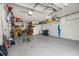 Spacious garage featuring storage shelves and a golf putting green at 2671 Lakebreeze S Ln, Clearwater, FL 33759