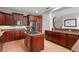 Spacious kitchen with a center island gas cooktop, stainless steel appliances, and granite countertops at 2671 Lakebreeze S Ln, Clearwater, FL 33759