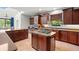 Gourmet kitchen with central island, breakfast bar and stainless steel appliances at 2671 Lakebreeze S Ln, Clearwater, FL 33759