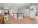 Second-floor landing featuring a wood floor, white walls, and a railing with a wood accent at 2671 Lakebreeze S Ln, Clearwater, FL 33759
