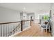 Second floor landing featuring wood floors and a staircase with white railing and stained wood accents at 2671 Lakebreeze S Ln, Clearwater, FL 33759