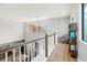 Bright landing area featuring hardwood floors, modern decor, and natural light from a large window at 2671 Lakebreeze S Ln, Clearwater, FL 33759