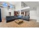 Bright, open living room featuring second story with kitchen and large sectional at 2671 Lakebreeze S Ln, Clearwater, FL 33759